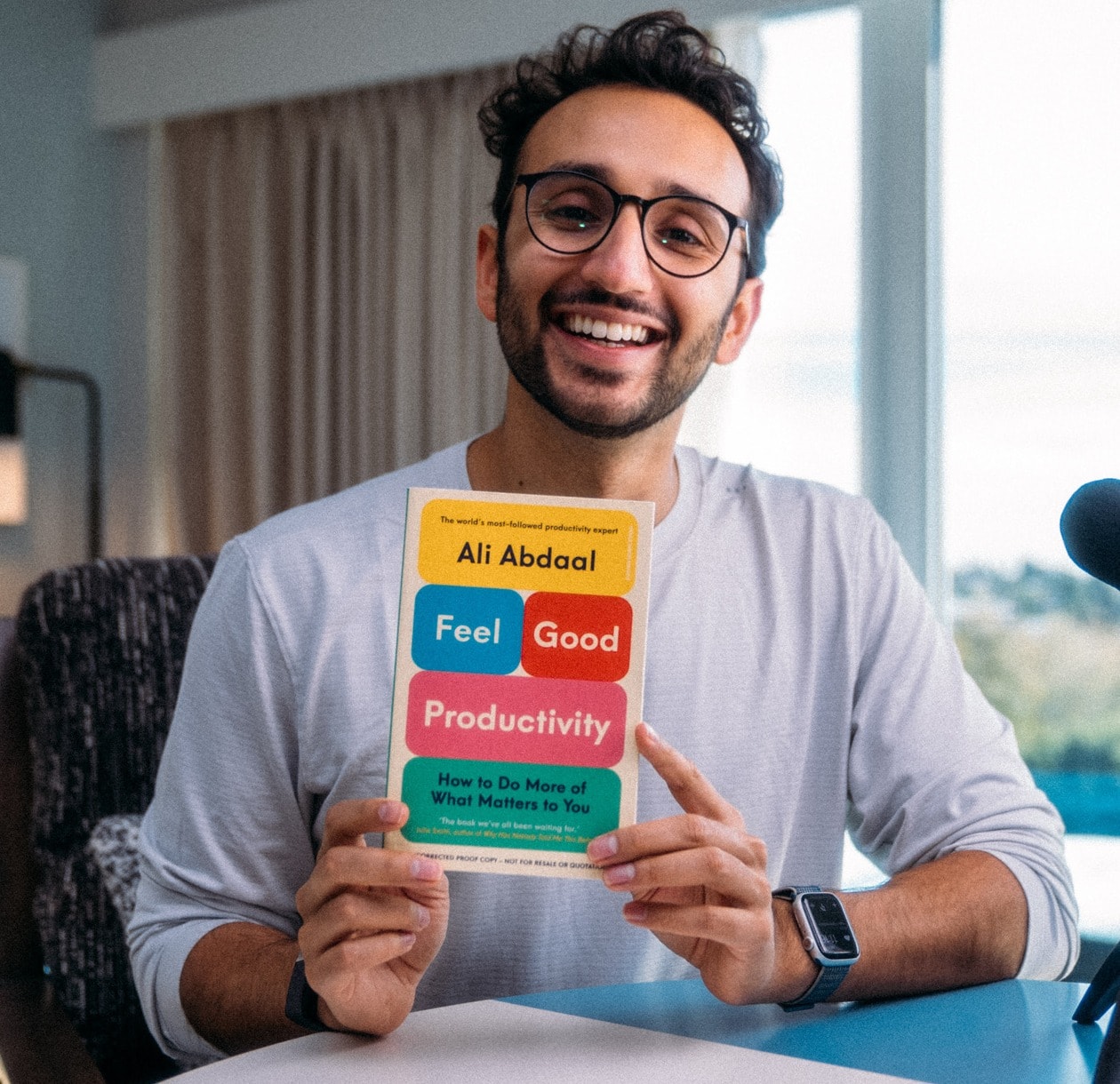 Ali Abdaal holding Feel-Good Productivity
